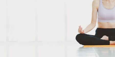 Fit young woman doing exercises of yoga, Calm and relax concept,wellness and healthy lifestyle,leaveの写真素材