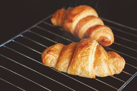 Dark mood background and fresh croissants on board.Free space for your decoration の写真素材