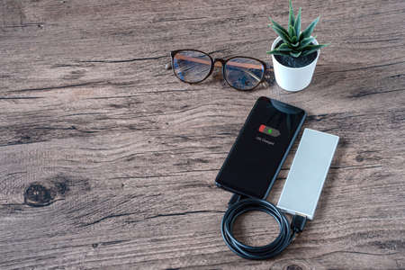 Phone connect to power bank on top viewの写真素材