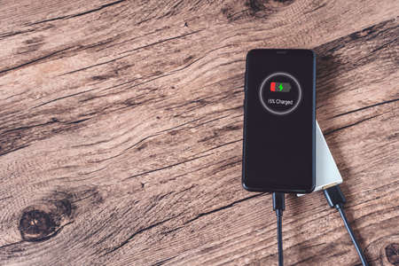 Phone connect to power bank on top viewの写真素材