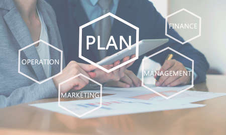 Successful young consultants working in an office, business plan conceptの写真素材