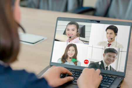 Asian woman wearing earphone and meeting in VDO call conferennce in meeting room, business concept.の写真素材