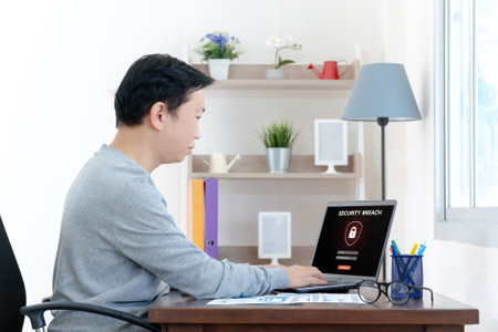 Security breach warning on laptop screen, device infected by internet virus or malware after cyberattack by hacker, fraud alert with red padlock iconの写真素材