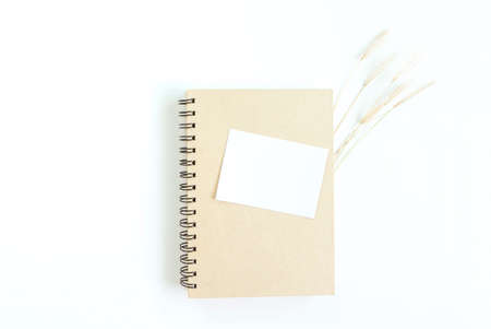 notebook with of dry grass on white background. flat lay, top view, copy space. Work and study placeの写真素材