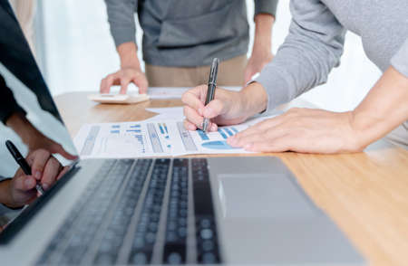 Hand of businessman point to graph. is discussing together in conference room talk about Report,...