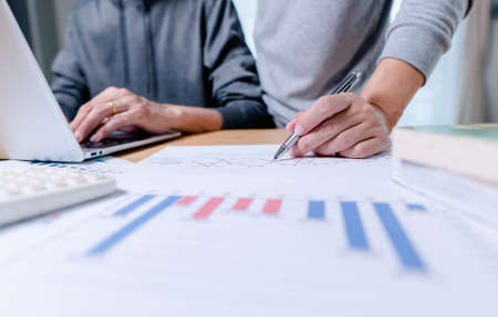Hand of businessman point to graph. is discussing together in conference room talk about Report,...