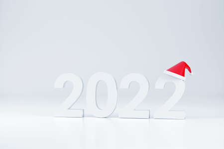 3D. 2022 font and Santa Claus hat At Christmas and New Year on a white backgroundの写真素材