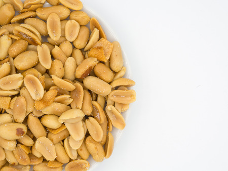 close up shot of roasted peanuts and sliced garlics seasoning with salt and sugar