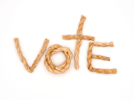 the word vote place in the center of the frame by pieces of brown robe on white background