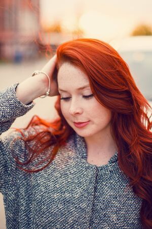 Olesya red-haired model on a sunset backgroundの写真素材
