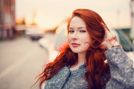 Olesya red-haired model on a sunset backgroundの写真素材
