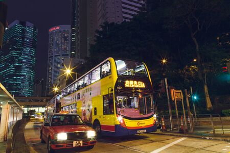 China Hong Kong 2016 December 31 Taxi and double-decker bus at the traffic lightのeditorial素材