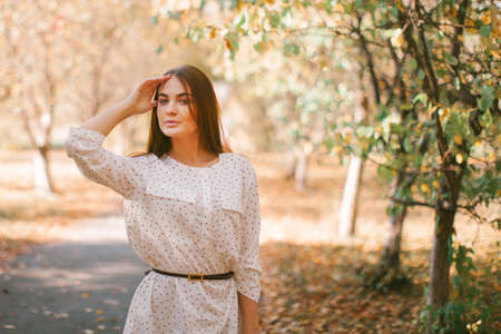 Girl walks in a dress and hat in the park.の写真素材