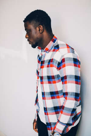 Black guy in shirt posing on white backgroundの写真素材