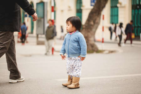 Vietnam. Hanoi. January 13, 2018. Adorable local little girl having fun in the city centerのeditorial素材