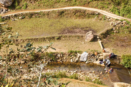 Women from small ethnic groups wash their clothes in a stream. Sapa. Vietnamの写真素材