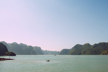 Scenic view on rock islands with fishing boats in Ha Long Bay. Cat Ba, Vietnam.の写真素材