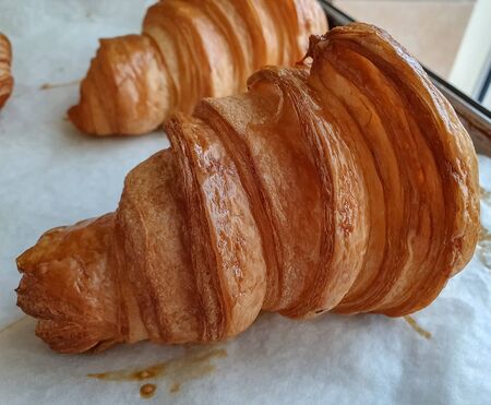 Fresh croissant on white background. Top view, background, Rustic. Bakery concept の写真素材
