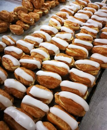 Close up French dessert eclairs with filling and glazes. Backgroundsの写真素材