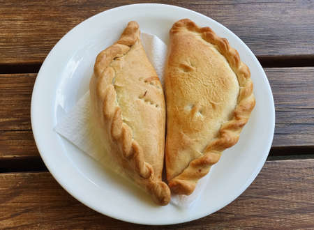 Karaite traditional food kibinai in Trakai Lithuania Europe. Wooden dark rustic background. Foodの写真素材