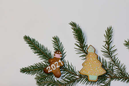 Christmas or winter composition. White background, gingerbread with a face mask with spruce branch decoration. Christmas background, Christmas, winter, new year concept. Flat lay, top view, copy spaceの写真素材