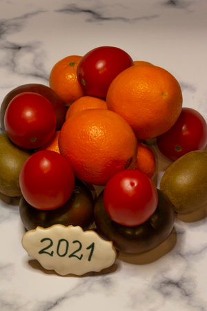 fruits and vegetables with 2021 like a promise to eat healthier next year. White gray marble background. Food and promiseの写真素材