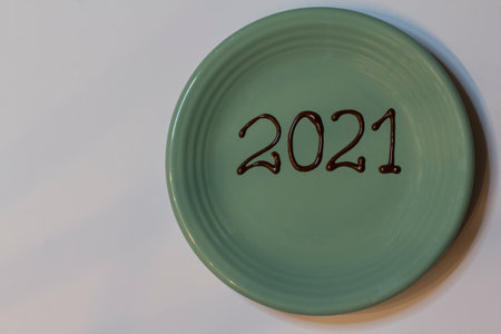 2021 is written on a green rustic plate on whiteの写真素材