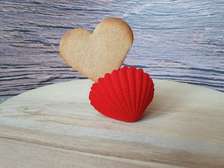 heart-shaped homemade gingerbread placed in a red jewelry box on a light wooden background. Valentines Day, greeting card, pastry, Copy space, top view, love concept, Engagement, love, marriageの写真素材