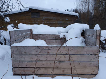 Wood compost bin in winter, food waste composted. Lets protect nature concept, ecological composting of food and garden waste, safe the planet conceptの写真素材
