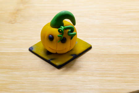 Halloween party background, Fondant paste figure pumpkin on wooden rustic background, copy space, card, invitation, cupcakes topper halloweenの写真素材