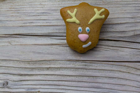 gingerbread cookie decorated with icing sugar on vintage rustic wooden background. Christmas food, pastry background. New Year theme. Merry Christmas and Happy New Year Holidays greeting card, frame, banner, copy spaceの写真素材