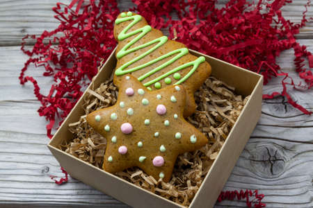 Christmas star gingerbread in gift box, wooden rustic background. Christmas background. New Year theme. Merry Christmas and Happy New Year Holidays greeting card, frame, banner, copy space, pastry artの写真素材