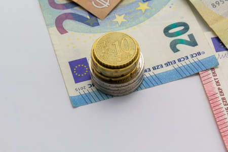 Money as background, euro coins and banknotes on white background. Money and financial conceptsの写真素材