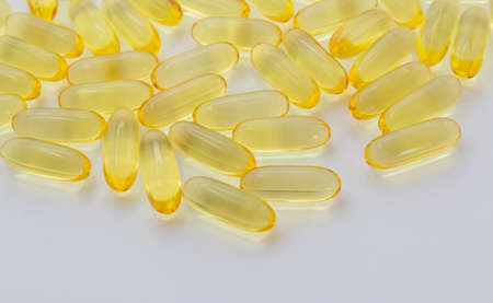 fish oil capsules on white background, health care background, balanced diet copy space top view horizontalの写真素材