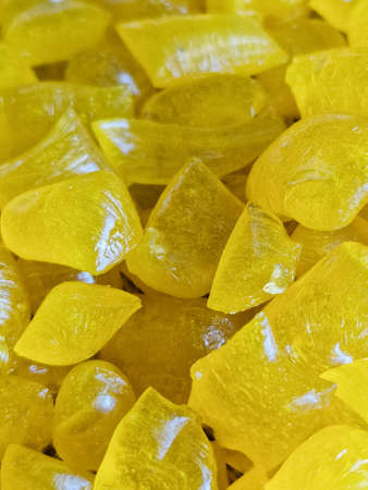 yellow homemade hard candy as background, pastry, copy space, greeting card, postcard, banner, cover, mockup, for your design, verticalの写真素材