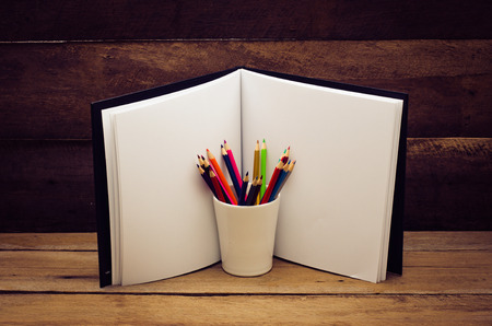 Color pencil and sketchbook on wooden backgroundの写真素材