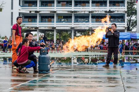 LAMPHUN, THAILAND- Jan 10, 2015:National Children's Day in Thailand.Children are doing on the fire with Fireman in Lamphun and Children's Day in Thailand on 10 January 2015.のeditorial素材
