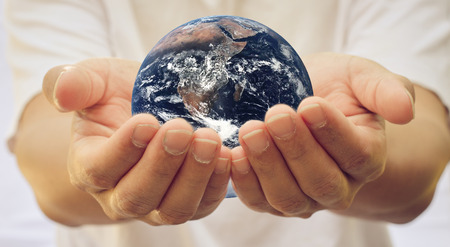 Globe with open hands inside the Earth.の写真素材