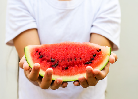 red watermelon in handの写真素材