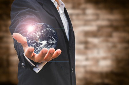 Businessman hand holding a globeの写真素材