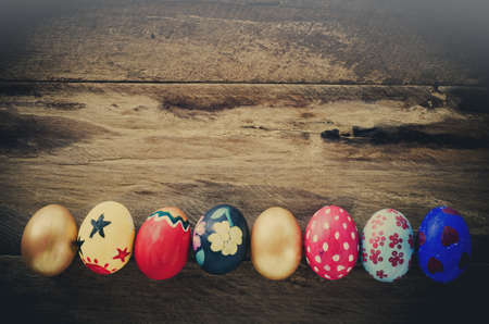Easter eggs in nest on wooden backgroundの写真素材