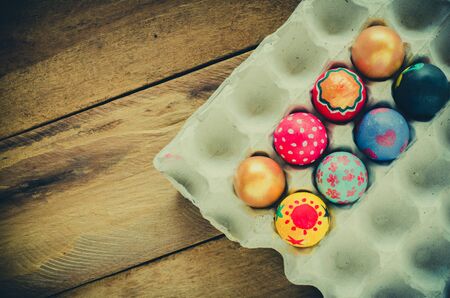 Easter eggs in nest on wooden backgroundの写真素材