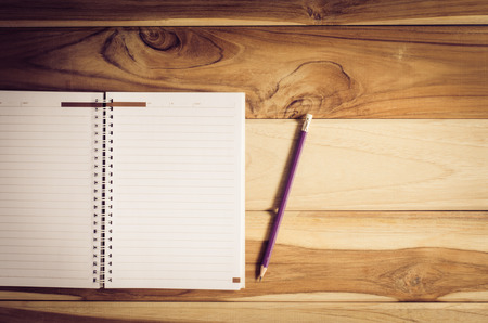 blank notebook with pencil on wooden table  still lifeの写真素材