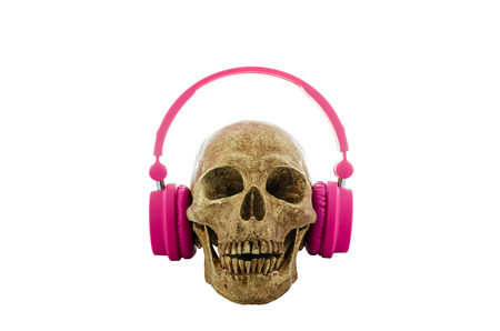 Skull with pink headphones isolated on white backgroundの写真素材