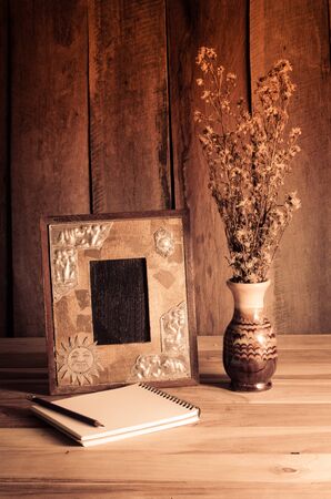 Still life picture frames vases dried rose notebook concept frequent memories