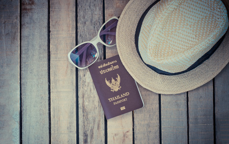 The concept of travel, hats, sunglasses, passport on wood. Get ready to travelの写真素材