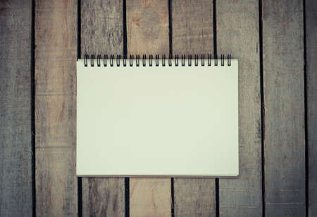 White notebooks laying on a wooden table - still lifeの写真素材