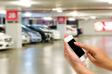 Phone in the blur parking lot.の写真素材