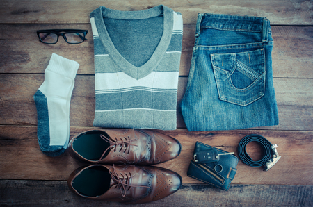 Travel accessories. Shirts, jeans, belts, wallets, glasses, car keys ready for the tripの写真素材