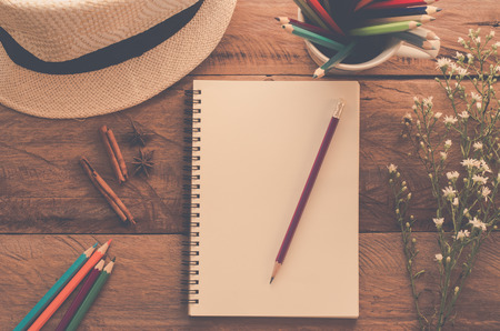 notebook pencil color pencil on wood table - tone vintage.の写真素材